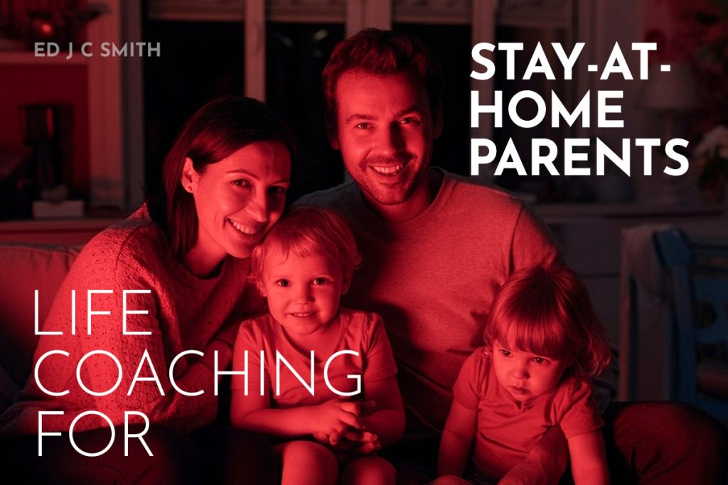 A happy family of four, featuring two parents and their young children, sitting together in a cozy, warmly lit environment. The text overlay says "Life Coaching for Stay-at-Home Parents" and includes the name "Ed J C Smith."