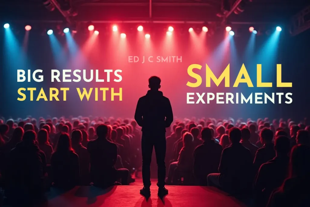 Silhouette of a speaker standing on stage before a large audience, under dramatic lighting, with the motivational quote "Big Results Start with Small Experiments" — perfect visual for illustrating how coaching goals are achieved through iterative testing and action.